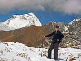 502 Jjerome Ryan And First View Of Dhaulagiri From Thulo Bugin Returning To Lete Up at 6:00, -1C in tent, -5C outside, it lightly snowed again last night. Breakfast: fried eggs on pancake. Sun hit our camp at 8:20, left at 8:30. After the trek to Annapurna North Base Camp, I didn't think it could get worse, but it did. This morning's trek was worse. First of all, the snow covered the trail making it worse to walk. Secondly, where the snow had melted, it was slushy slippery mud. Thirdly, it was mostly downhill, steeply downhill. Add to that crossing raging streams, and a few falls (mine, that is), and by the time I arrived at our lunch stop at 11:50, I was both mentally and physically spent. After a lunch of French fries, pan-fried bread and yak cheese, we left at 13:25, arrived at the April 27 pass at 14:55, and down to the Shepherds Kharka camp at 16:15.